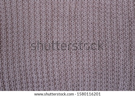Pink knitted woolen fabric, close-up
