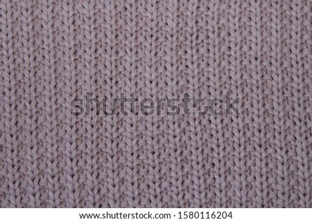 Pink knitted woolen fabric, close-up
