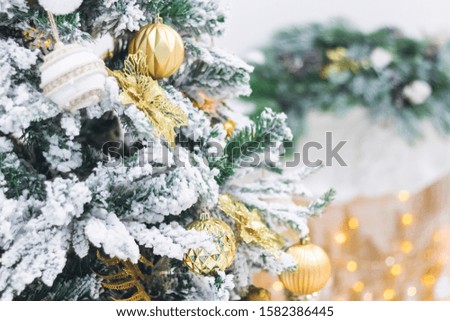 Christmas tree with toys and gifts light snow covered