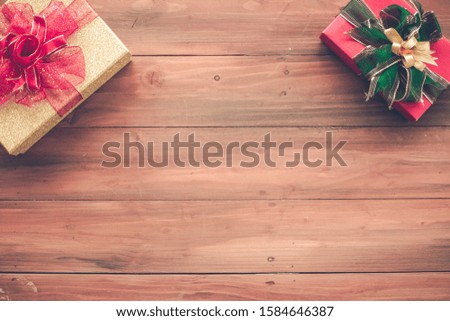 Top view of Christmas composition with gift boxes on wooden background and copy space. Accessories of Christmas and new year concept.