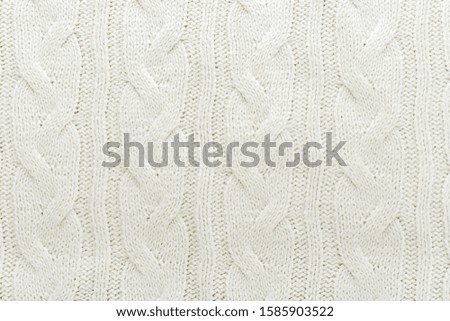 Beige knitted fabric wool texture for background. Close up of White Knitted material pattern for design. Beige warm sweater textile background.