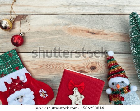 Close up gift box, snowman, sock, ornament and toy pine tree on old wood table, copy space background for text, merry christmas and happy new year, hello holiday season concept