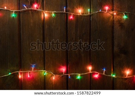 Christmas background. planked wood with lights and free text space