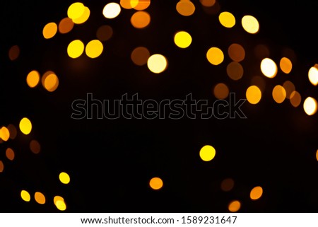 Golden sparkles festive background. Bokeh lights with bright shiny effect illustration. Overlapping glowing and twinkling spots decorative backdrop. Abstract glittering circles
