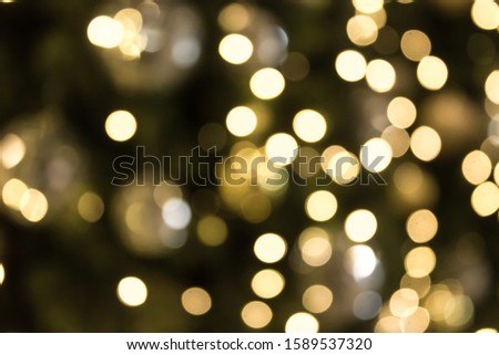Christmas with gold bokeh light background. Xmas abstract blur and glowing decorations outdoors.