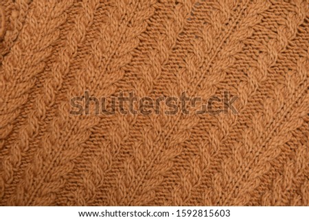 Knitted seamless texture fabric. Brown Sweater close up.


