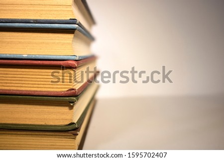 Many books stacked on white background