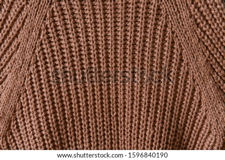 Brown knitted texture. Knitting pattern of wool. Knitting. 


