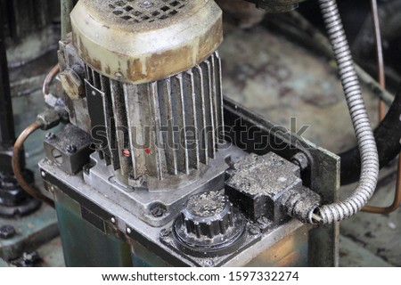 Old industrial electrical oil pump with vertical power asynchronous motor for machine tools hydraulic system