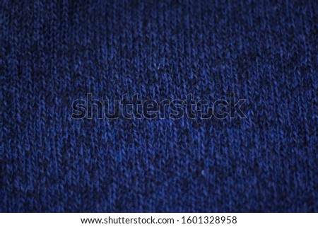The texture of a knitted woolen fabric blue. Background