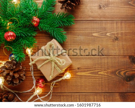 Top view,flat lay Gift box and Christmas ornaments on brown wooden background with copy space.Xmas,Happy new year concepts