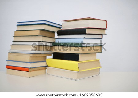 Stack of books on table with white background