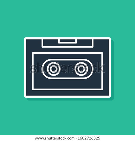 Blue Retro audio cassette tape icon isolated on green background.  