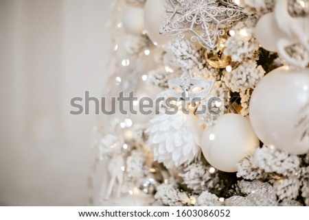 Christmas tree in silver decor in the interior