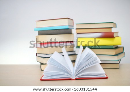 Stack of books on table with white background