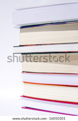 pile of colorful books set against a white background