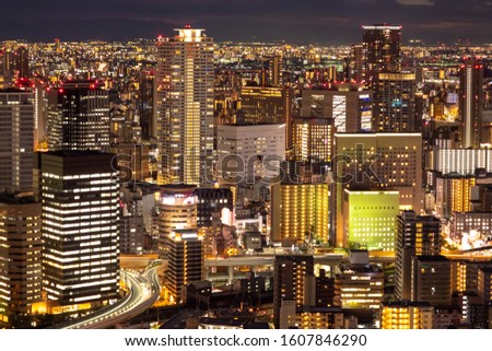 Japan. Osaka in the evening. The business center of Osaka. Office buildings with lighted Windows. View of the evening city from a height. Business centers of Osaka. Travelling to Japan.