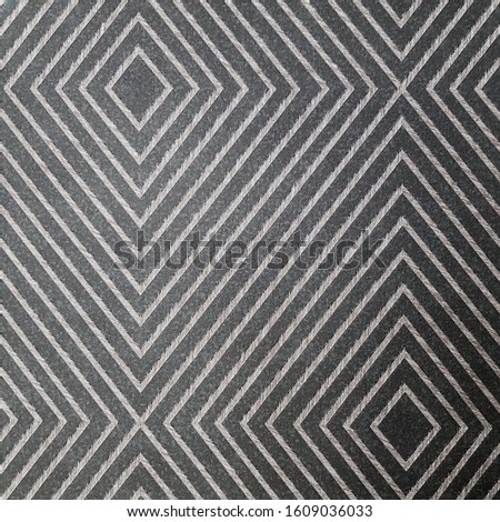 Black and white ceramic tile with geometric pattern for wall and floor decoration. Concrete stone surface background. Texture for interior design project. 