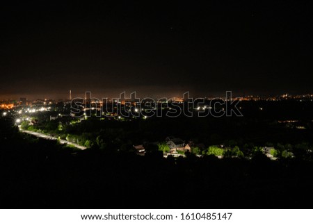 Aerial view of night town from Hill after sunset - modern city with spectacular nightscape panorama. aerial view, night city with night sky. natural summer night. horizontal