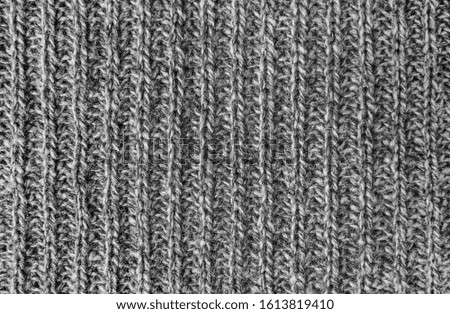 Texture of gray woolen knitted sweater closeup