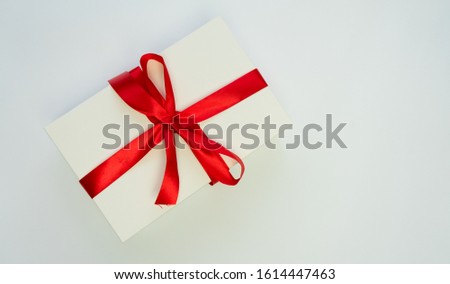 White box, red ribbon on white backgraund, isolated