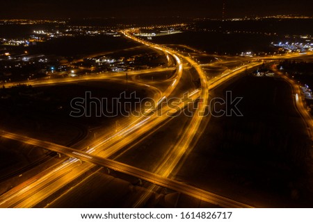 Aerial view of a highway with cars at night. Poland. Drone shot Above of elevated road junction and traffic an important transport at night. 