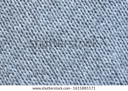 Gray woolen knitted texture as background
