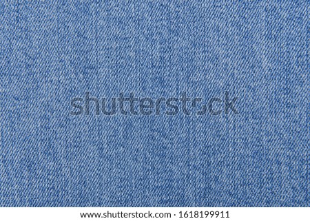 blue denim jeans background with a seam. Jeans fashion design


