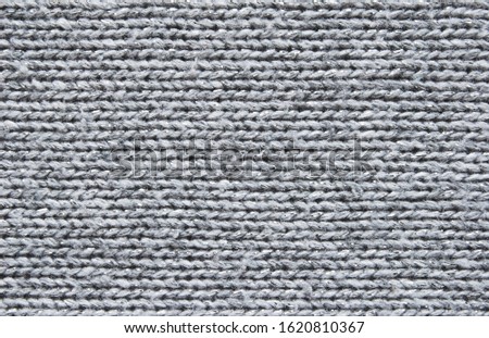 Gray knitted fabric texture with metallic fibers as background