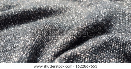 Black fabric with lurex in the folds (texture).
