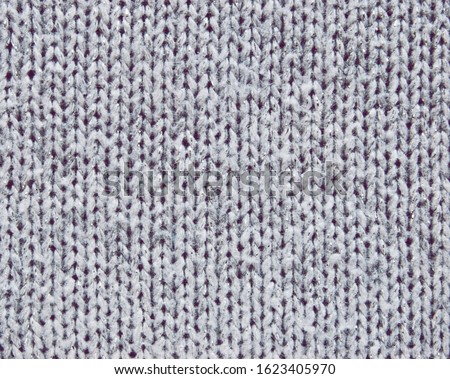 Gray stockinette knit texture with metallic fibers as background