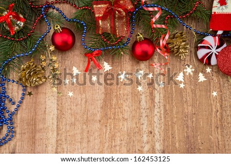 Christmas Decoration Over Wooden Background. Beige paper  card background with Christmas border