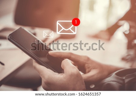 Woman hand use smartphone in public area with 1 new email alert sign icon pop up. Communication business technology concept.