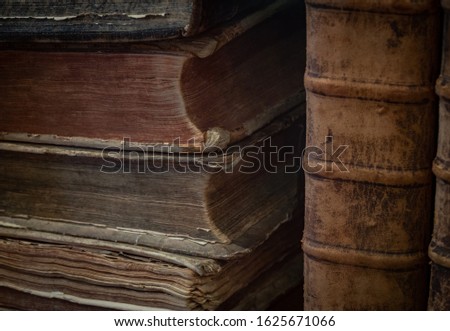The ancient and vintage books in a bookcase .