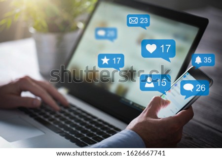Like and share social media. Hands holding smartphone with social media network icons. Marketing concept.