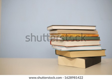 Stack of books on blue background