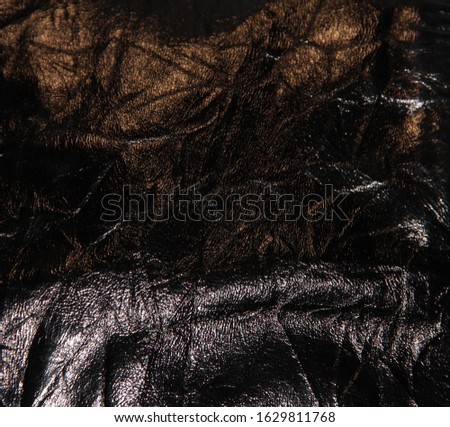 Texture of crushed black leather.