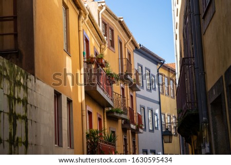 The narrow streets of Porto, Portugal with colorful buildings and balconies