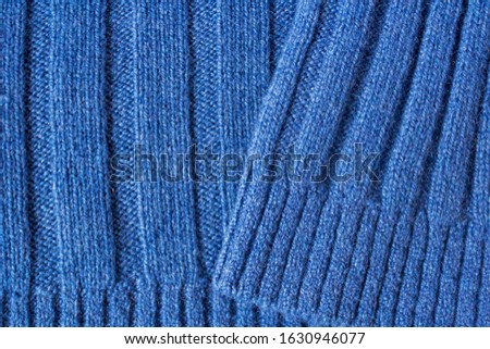 Uniform texture of expensive, exclusive knitwear made of cashmere, wool and viscose. Warm, cozy, knitted sweater for cold weather