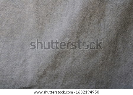 Crumpled fabric texture background in gray.