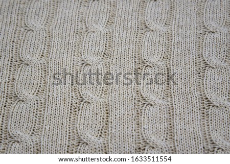Full frame of knitted grey plaid as a backdrop. Horizontal grey background pattern. Copy space for text, design.