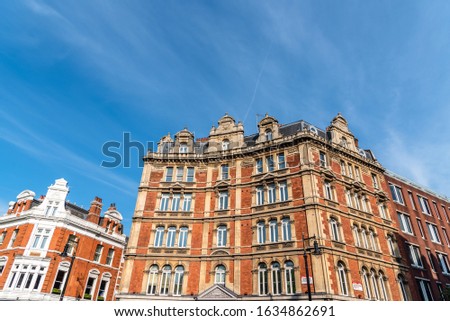Old residential buildings in the city of London against blue sky.