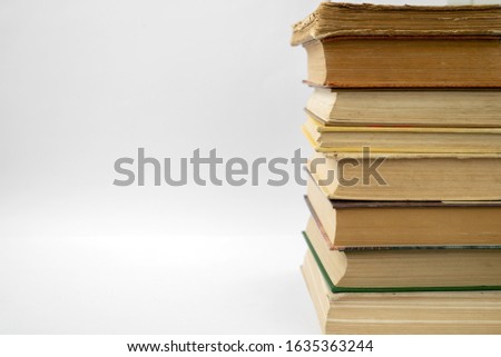
Old books on a light wall background
