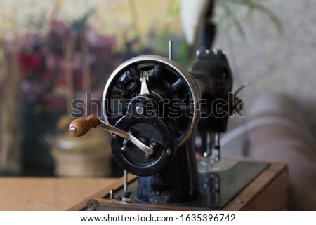 Machine pulley with wooden handle as part of old manual sewing machine