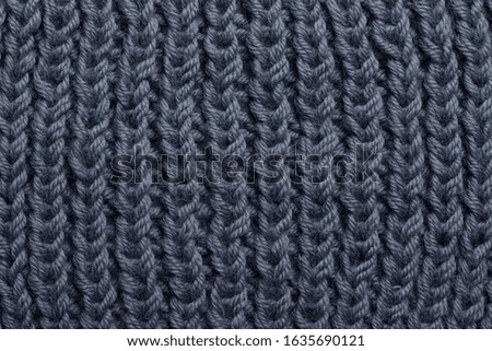 
knitted gray background, texture of a knitted plaid from merino wool