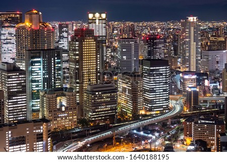 Japan. Osaka. Evening panorama of the big city. View of Osaka business center from a height. Buildings with glowing Windows and roads. Cities of Japan. Modern urban architecture.