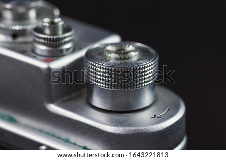 Detail of an old camera - controller, closeup. Retro camera in scratches and dust from a private collection.