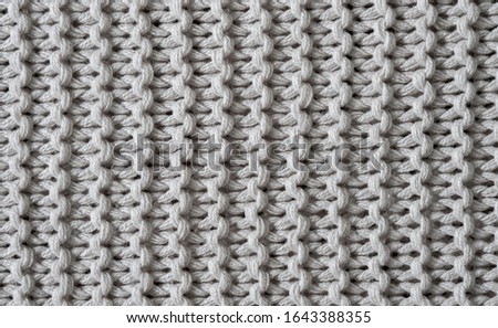 Seamless thick knitted white woollen texture background.