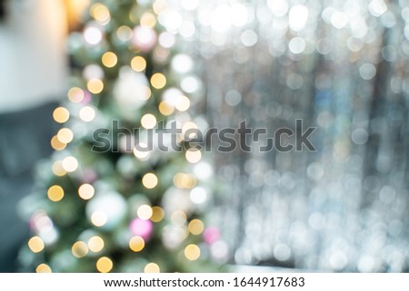 Christmas tree and silver tinsel blurred background. Festive backdrop for holiday design.