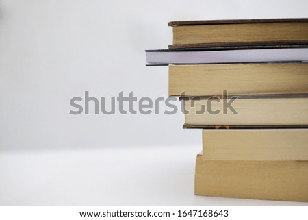 Stack of books on white table